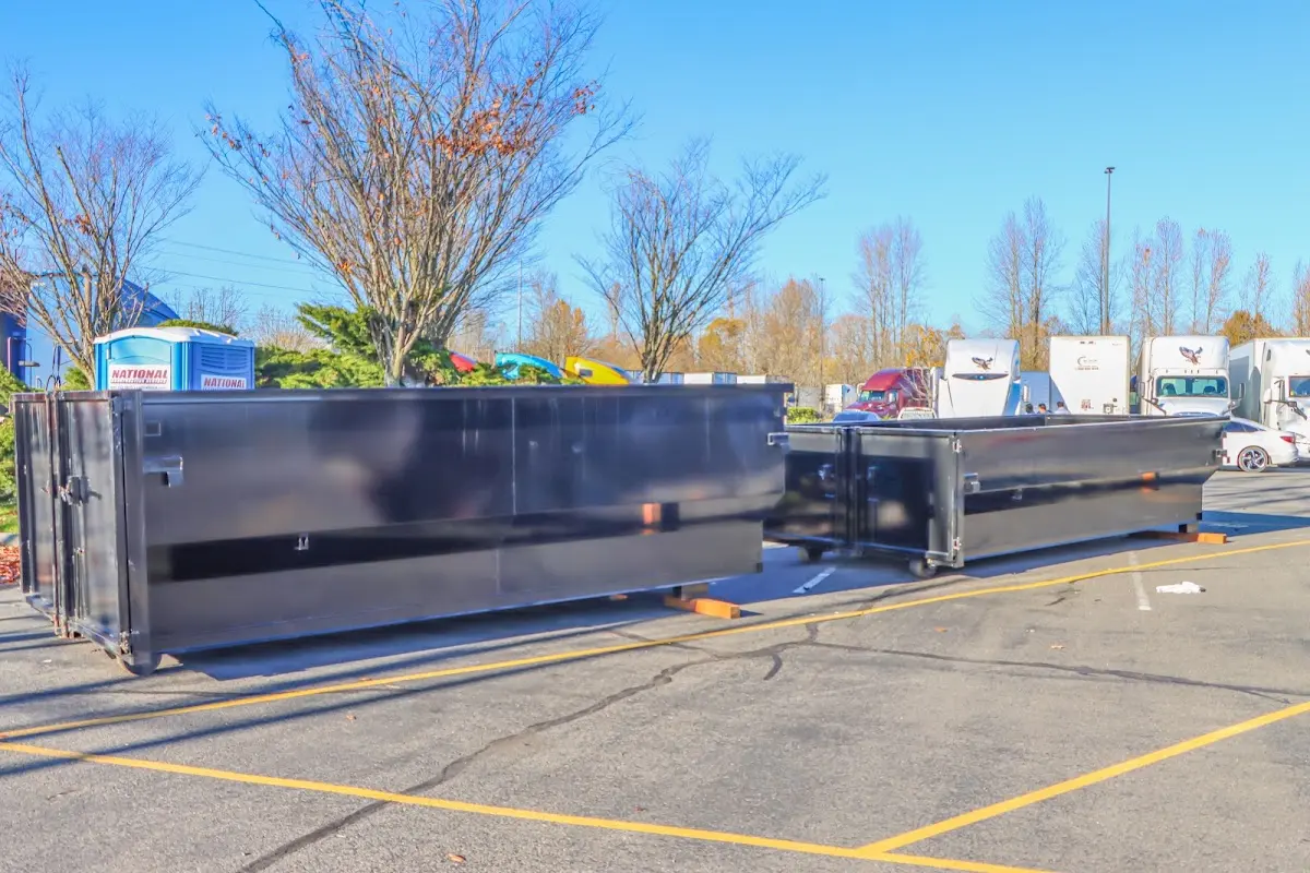 Professional dumpster rental service with roll-off container on residential driveway in Susanville